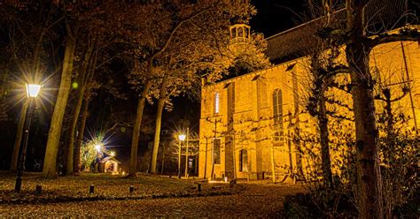 Interieur van een sfeervol verlichte kerk met een podium voor musici
