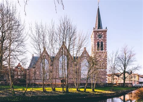 Interieur van de historische Dorpskerk in Aalsmeer met zitplaatsen en een kansel.