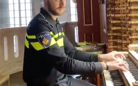 Een afbeelding van André Nieuwkoop die een politieman-uniform draagt en op een orgel speelt.